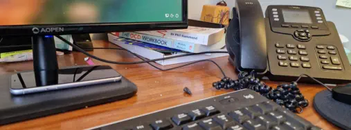 Office desk top with phone and computer