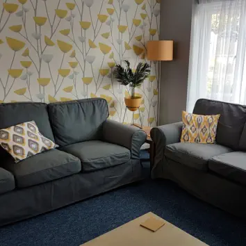 two sofas in front room of our social support drop-in
