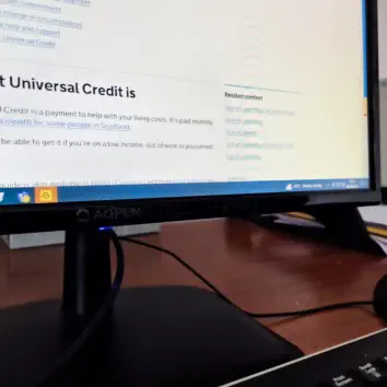 Desk with computer monitor showing beenfits application screen
